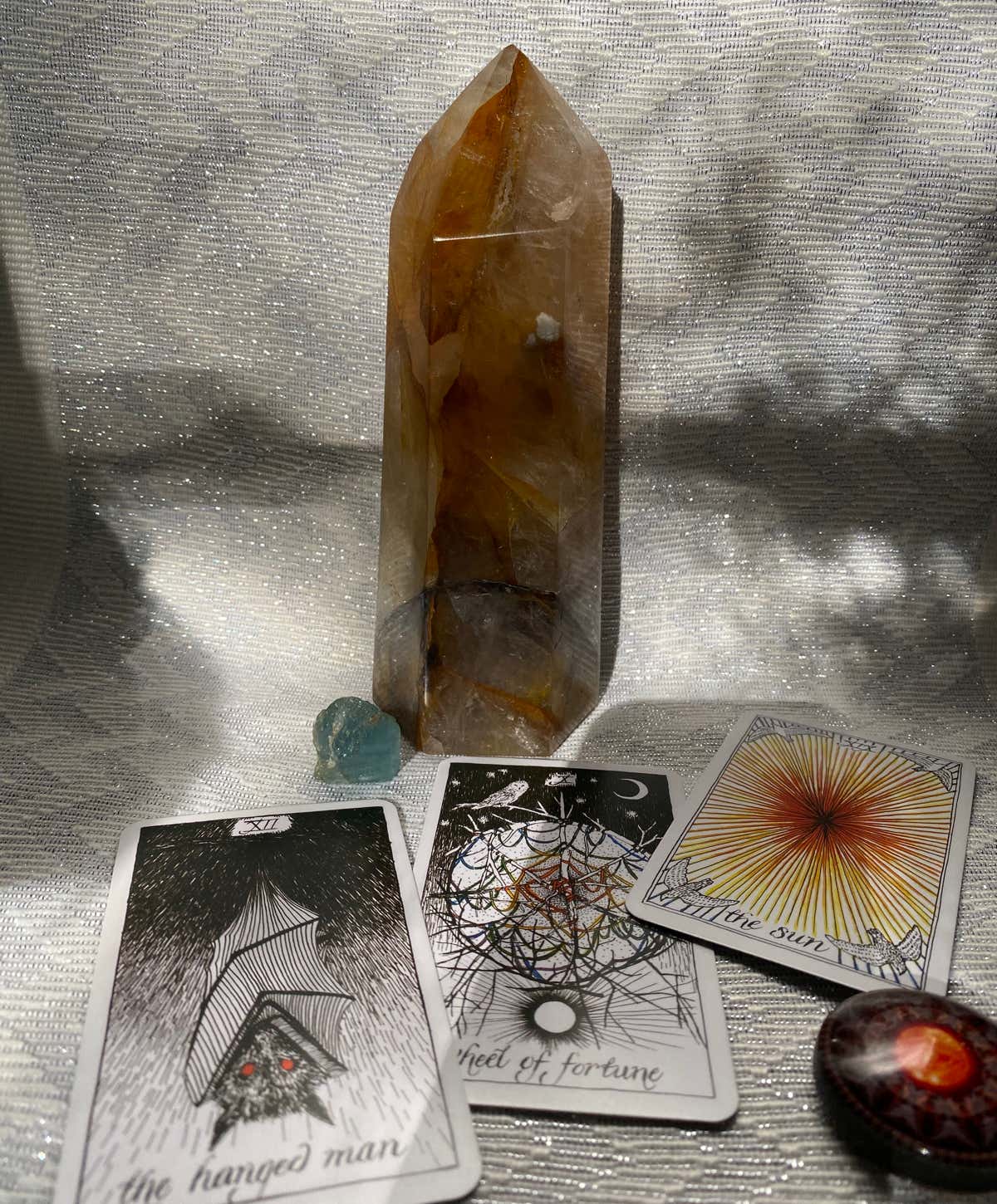 Tarot cards setting next to a Golden Healer Crystal